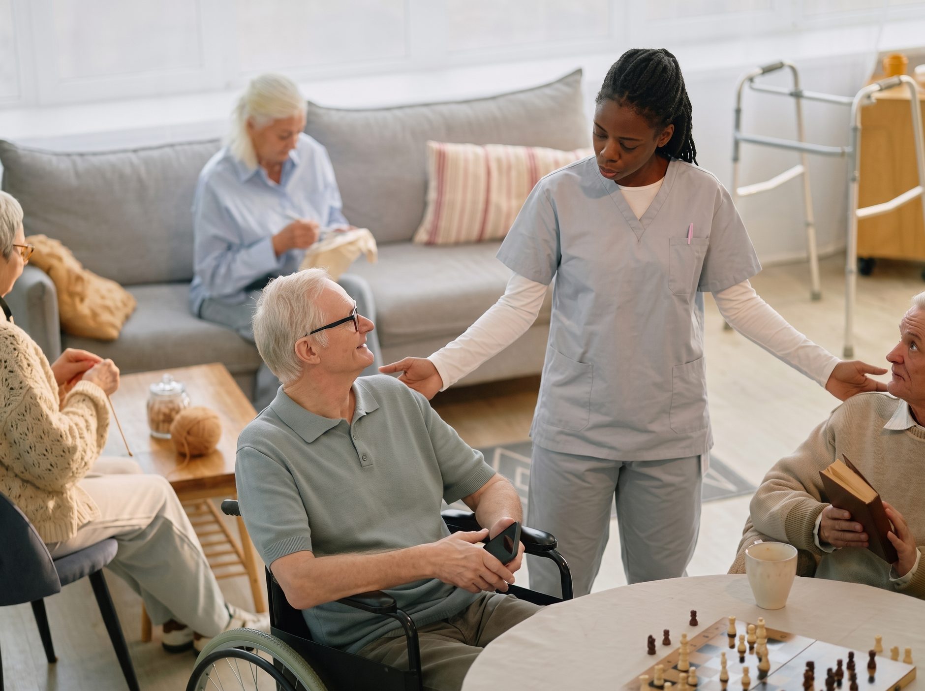 Caregiver with residents in an assisted living lounge